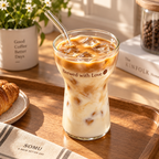 brewed with love glass with iced coffee milk ice and glass straw on wood