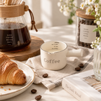 styled coffee tabletop with cream little coffee measure mug labeled coffee